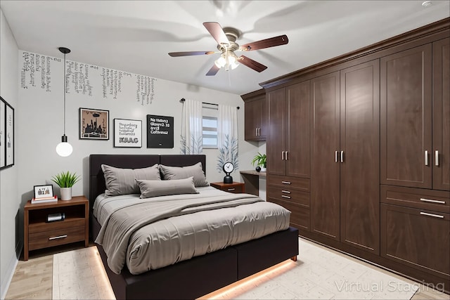 9445 W Kelvin Ln Unit 2992, Schiller Park, IL 60176 - bedroom featuring ceiling fan and light wood-style flooring