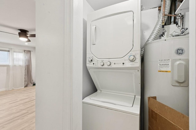 9445 W Kelvin Ln Unit 2992, Schiller Park, IL 60176 - washroom featuring stacked washer / dryer, water heater, and wood finished floors