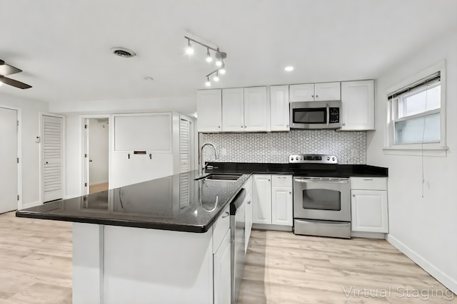 9445 W Kelvin Ln Unit 2992, Schiller Park, IL 60176 - kitchen featuring stainless steel appliances, white cabinetry, backsplash, and light wood-style floors