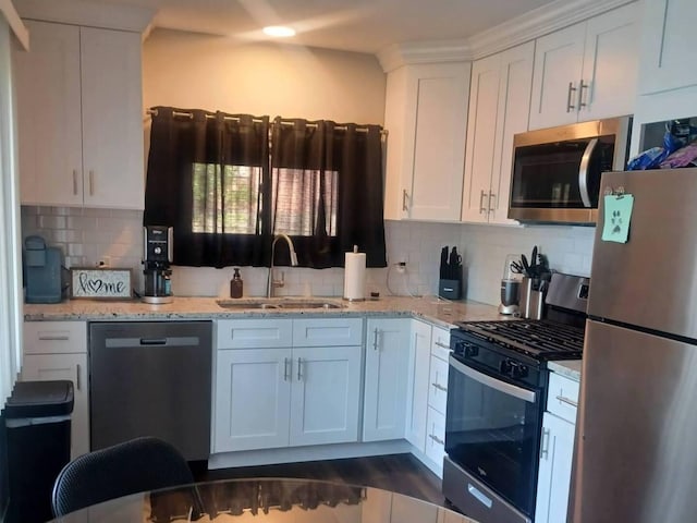 3114 W 163rd St, Markham, IL 60428 - kitchen with appliances with stainless steel finishes, white cabinets, decorative backsplash, and light stone counters