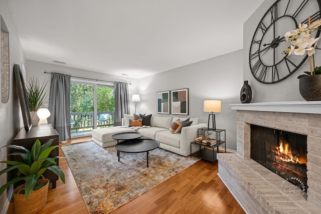 29W440 Emerald Green Dr Unit 25-F, Warrenville, IL 60555 - living room with a brick fireplace and wood finished floors