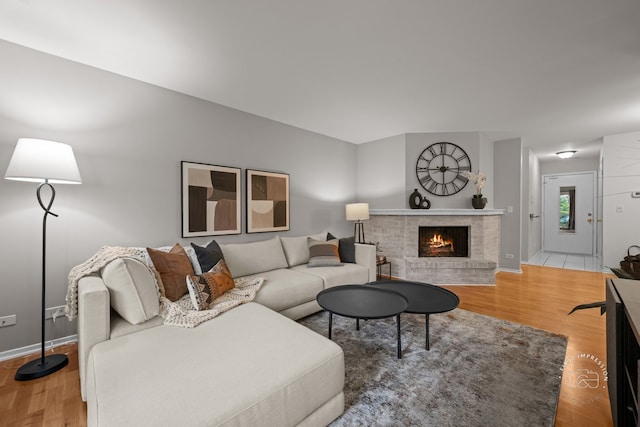29W440 Emerald Green Dr Unit 25-F, Warrenville, IL 60555 - living area featuring a brick fireplace and wood finished floors