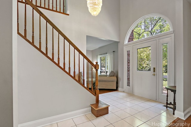 232 Bobolink Dr, Grayslake, IL 60030 - entrance foyer featuring plenty of natural light, stairs, a chandelier, tile patterned flooring, and a towering ceiling