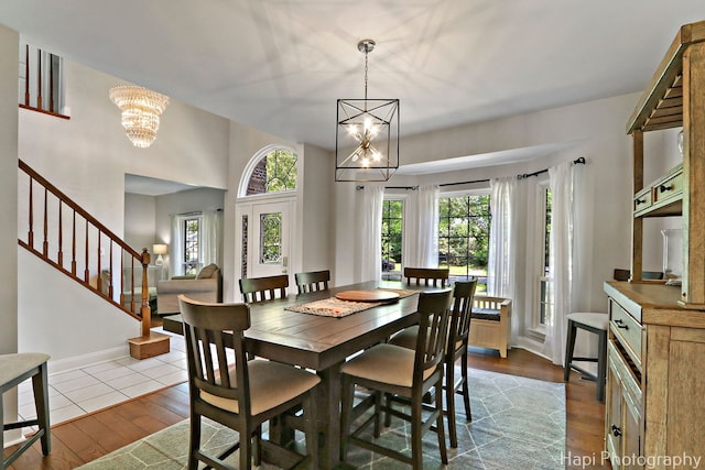 232 Bobolink Dr, Grayslake, IL 60030 - dining room featuring a chandelier, dark wood finished floors, and stairway