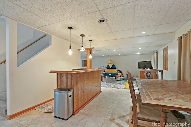 232 Bobolink Dr, Grayslake, IL 60030 - indoor dry bar featuring a paneled ceiling, light tile patterned flooring, pendant lighting, and stairway