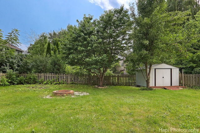 232 Bobolink Dr, Grayslake, IL 60030 - fenced backyard with a fire pit and a storage unit