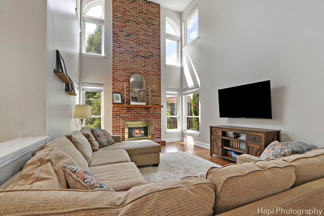 232 Bobolink Dr, Grayslake, IL 60030 - living area with a high ceiling, wood finished floors, and a brick fireplace