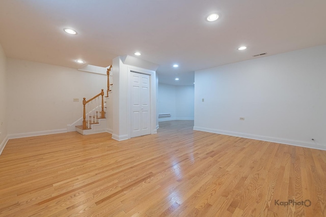 2318 S Central Park Ave Unit 101, Chicago, IL 60623 - finished below grade area with stairway, light wood-style floors, a baseboard heating unit, and recessed lighting