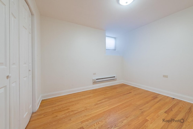 2318 S Central Park Ave Unit 101, Chicago, IL 60623 - unfurnished bedroom featuring a baseboard radiator, light wood-style floors, and a closet
