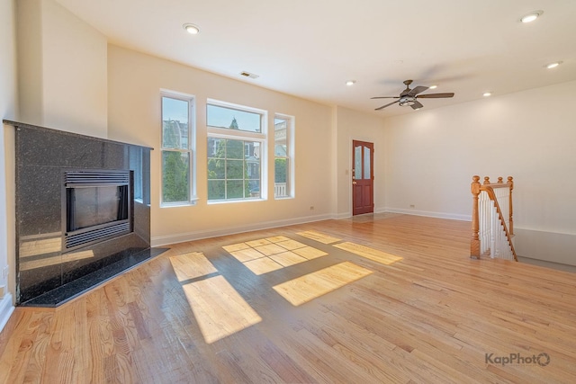 2318 S Central Park Ave Unit 101, Chicago, IL 60623 - unfurnished living room with light wood-type flooring, a fireplace, a ceiling fan, and recessed lighting