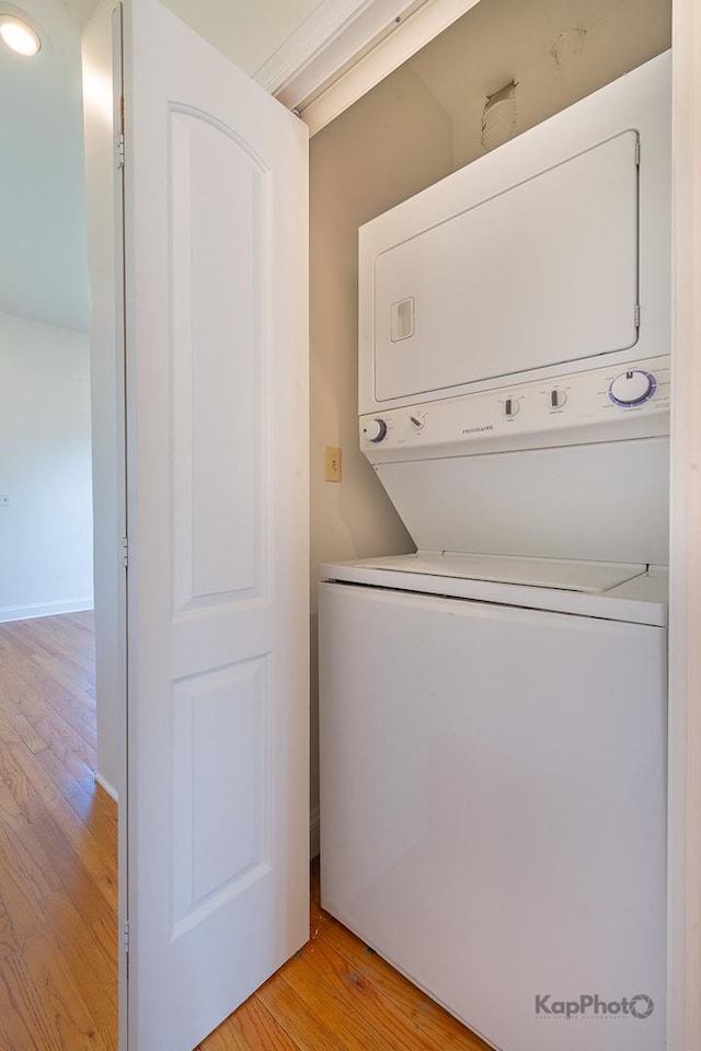 2318 S Central Park Ave Unit 101, Chicago, IL 60623 - laundry area with stacked washer and clothes dryer and light wood-style flooring