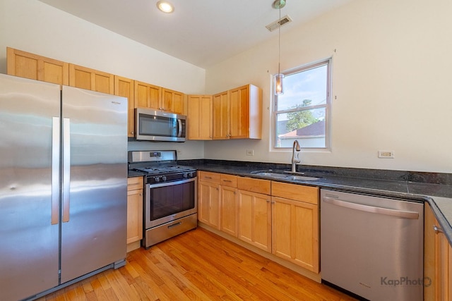 2318 S Central Park Ave Unit 101, Chicago, IL 60623 - kitchen with stainless steel appliances, light wood-style floors, decorative light fixtures, and recessed lighting