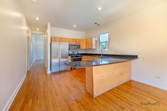 2318 S Central Park Ave Unit 101, Chicago, IL 60623 - kitchen featuring stainless steel appliances, a peninsula, light wood finished floors, recessed lighting, and pendant lighting