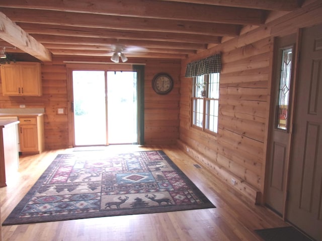 26901 W Burkhart Ln, Ingleside, IL 60041 - foyer entrance with light wood finished floors, beam ceiling, wood walls, and a ceiling fan