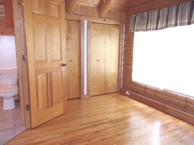 26901 W Burkhart Ln, Ingleside, IL 60041 - unfurnished bedroom featuring light wood-style flooring, multiple closets, and wood ceiling
