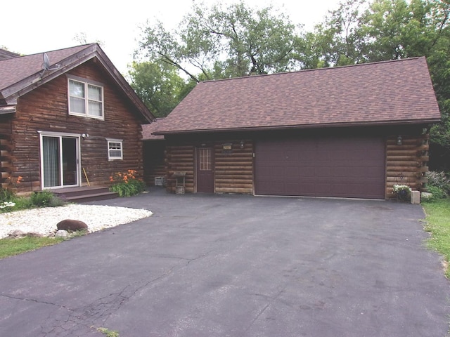 26901 W Burkhart Ln, Ingleside, IL 60041 - view of side of home with log exterior, roof with shingles, driveway, and an outdoor structure