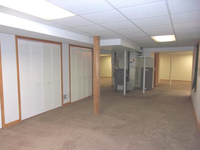 26901 W Burkhart Ln, Ingleside, IL 60041 - finished basement with heating unit, carpet flooring, and a paneled ceiling