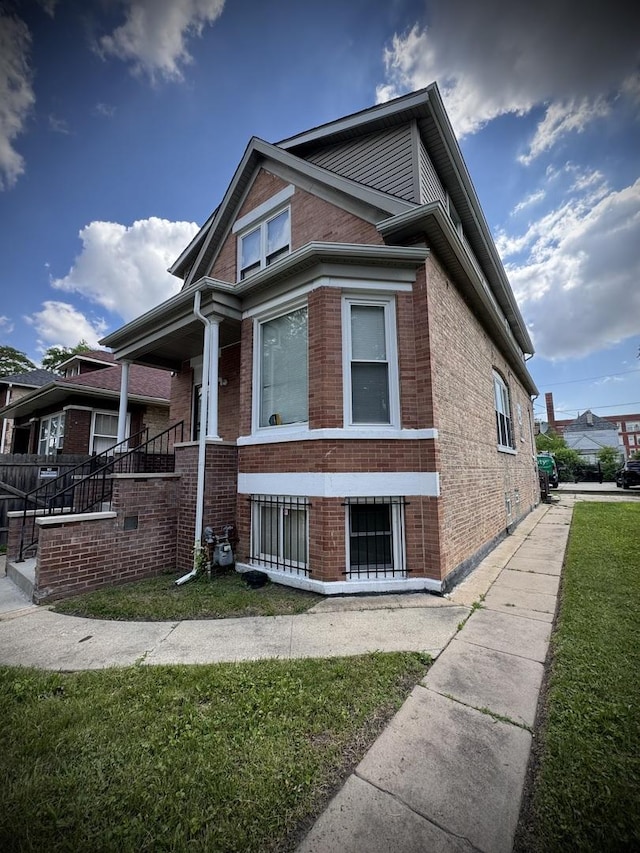 8513 S Sangamon St, Chicago, IL 60620 - view of front of home featuring brick siding, a front yard, and covered porch