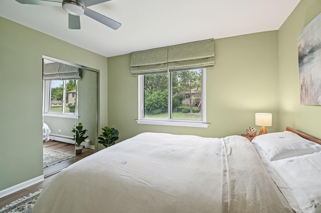 9S240 Lake Dr Unit 17-207B, Willowbrook, IL 60527 - bedroom featuring wood finished floors, ceiling fan, and a baseboard radiator