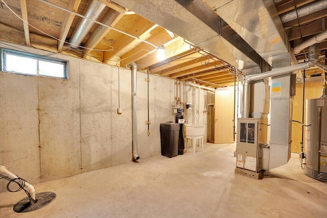 390 Madeline Trl, Rockford, IL 61107 - below grade area featuring heating unit, gas water heater, and a water softener