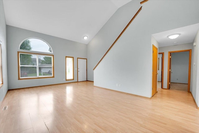390 Madeline Trl, Rockford, IL 61107 - unfurnished living room with wood finished floors and high vaulted ceiling