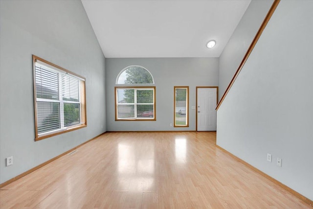 390 Madeline Trl, Rockford, IL 61107 - unfurnished living room featuring wood finished floors and high vaulted ceiling