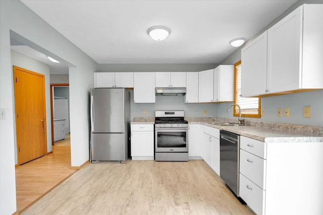 390 Madeline Trl, Rockford, IL 61107 - kitchen with appliances with stainless steel finishes, light wood-style flooring, under cabinet range hood, light countertops, and white cabinetry