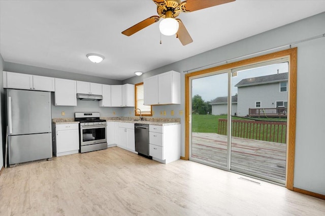 390 Madeline Trl, Rockford, IL 61107 - kitchen with appliances with stainless steel finishes, white cabinets, under cabinet range hood, a ceiling fan, and light wood-type flooring