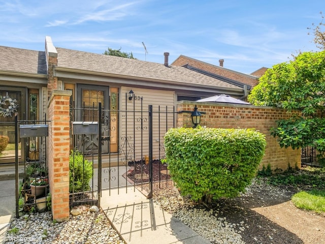 534 E Main St, Barrington, IL 60010 - doorway to property with roof with shingles, a gate, and brick siding