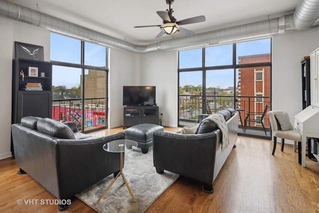 4011 N Francisco Ave Unit 310, Chicago, IL 60618 - living room featuring ceiling fan, wood finished floors, and plenty of natural light