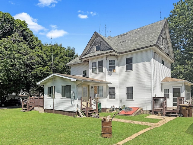 401 S Chestnut St, Shannon, IL 61078 - back of property with a wooden deck, a lawn, and roof with shingles