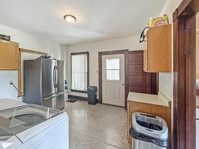 401 S Chestnut St, Shannon, IL 61078 - kitchen featuring freestanding refrigerator, washer / dryer, light countertops, and dark speckled floor