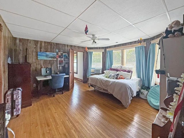 401 S Chestnut St, Shannon, IL 61078 - bedroom with wooden walls, light wood finished floors, ceiling fan, and a paneled ceiling