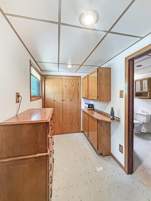 401 S Chestnut St, Shannon, IL 61078 - kitchen with brown cabinets, concrete floors, and light countertops