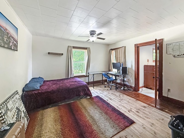 401 S Chestnut St, Shannon, IL 61078 - bedroom with wood finished floors, ceiling fan, and an office area