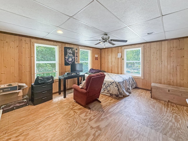 401 S Chestnut St, Shannon, IL 61078 - bedroom featuring multiple windows, wood walls, ceiling fan, a drop ceiling, and wood finished floors