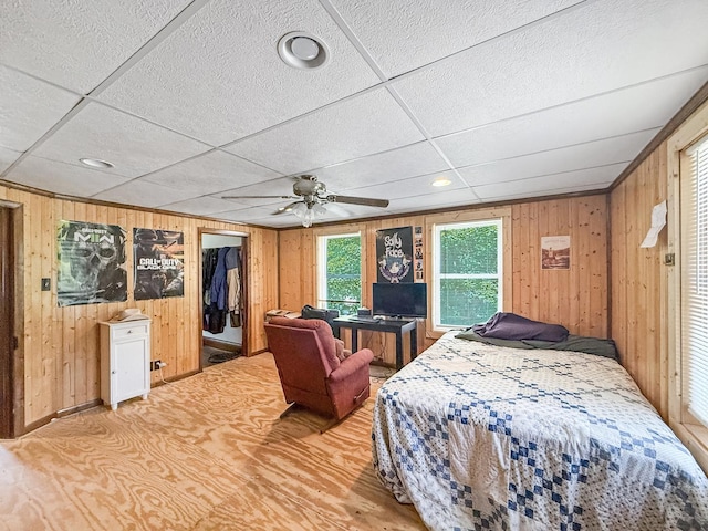 401 S Chestnut St, Shannon, IL 61078 - carpeted bedroom featuring wooden walls, a ceiling fan, and a closet