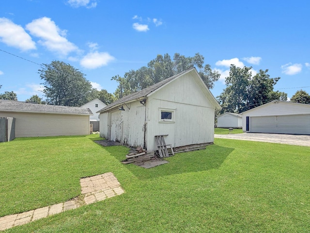 401 S Chestnut St, Shannon, IL 61078 - view of side of home featuring an outdoor structure, a yard, and a garage
