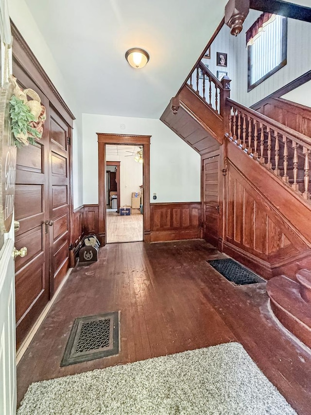 401 S Chestnut St, Shannon, IL 61078 - entryway featuring wood-type flooring, stairway, wainscoting, and wooden walls