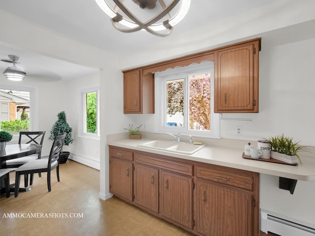 513 Chaney Ave, Crest Hill, IL 60403 - kitchen featuring baseboard heating, brown cabinetry, light countertops, and a chandelier