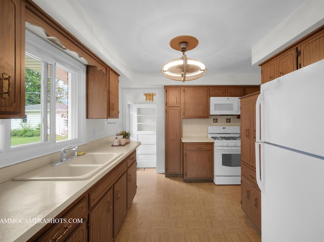 513 Chaney Ave, Crest Hill, IL 60403 - kitchen with white appliances, light countertops, brown cabinetry, and light flooring