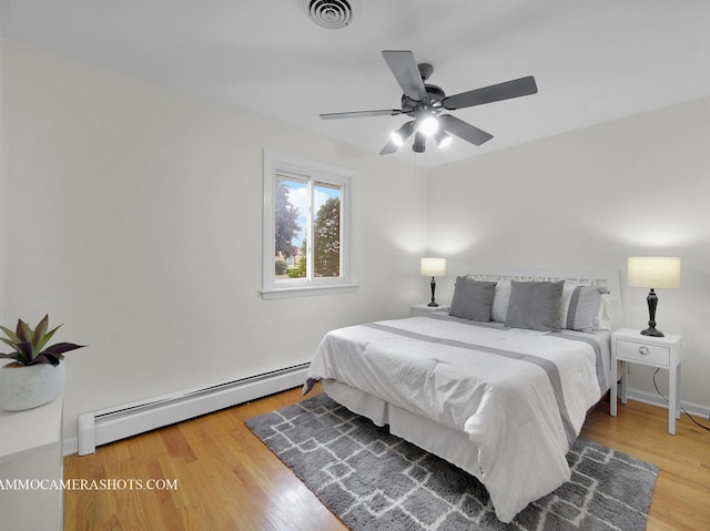 513 Chaney Ave, Crest Hill, IL 60403 - bedroom with a baseboard radiator, wood finished floors, and ceiling fan