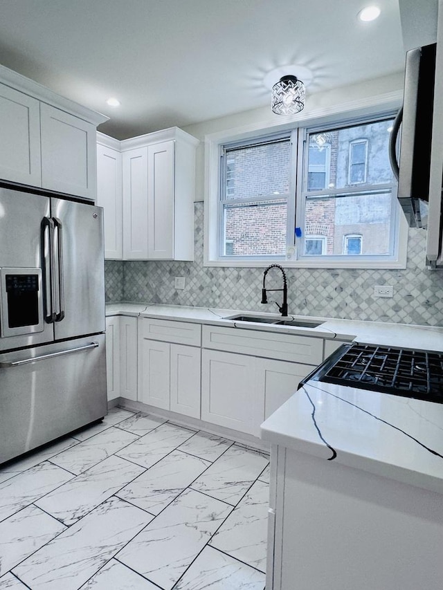 7253 S Marshfield Ave, Chicago, IL 60636 - kitchen with stainless steel appliances, light marble finish floors, white cabinets, recessed lighting, and tasteful backsplash