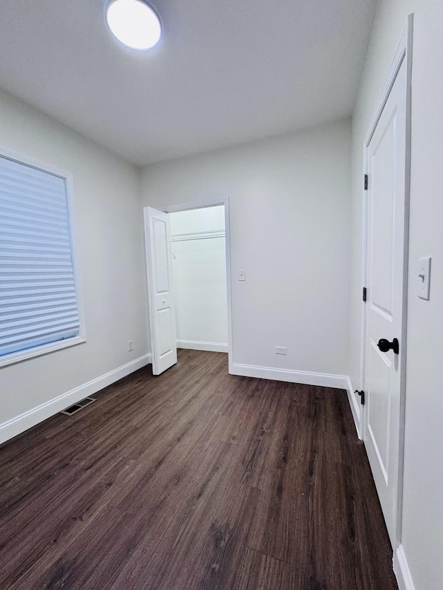 7253 S Marshfield Ave, Chicago, IL 60636 - unfurnished bedroom featuring dark wood-style flooring and baseboards