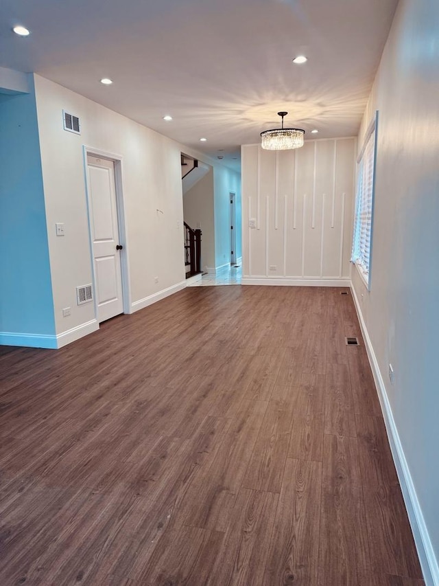 7253 S Marshfield Ave, Chicago, IL 60636 - unfurnished living room featuring stairway, recessed lighting, dark wood-type flooring, and a chandelier