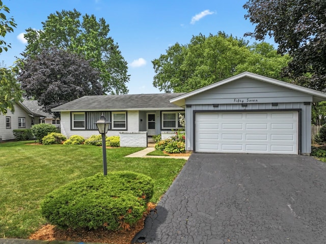 57 Kenilworth Ave, Elk Grove Village, IL 60007 - ranch-style home with asphalt driveway, a front lawn, a garage, board and batten siding, and roof with shingles