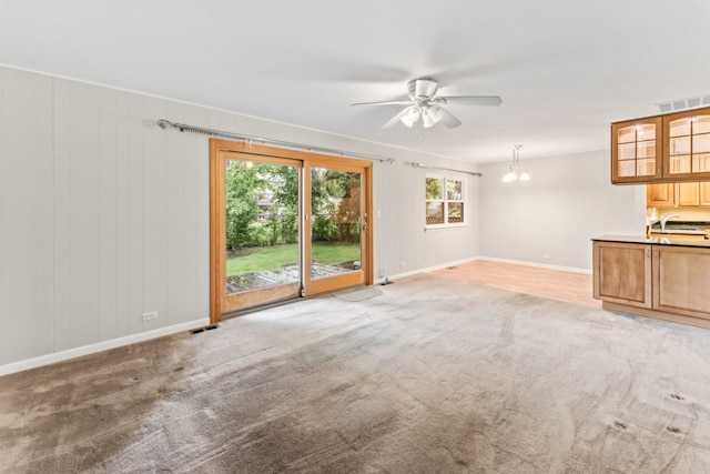 57 Kenilworth Ave, Elk Grove Village, IL 60007 - unfurnished living room featuring a ceiling fan and light colored carpet
