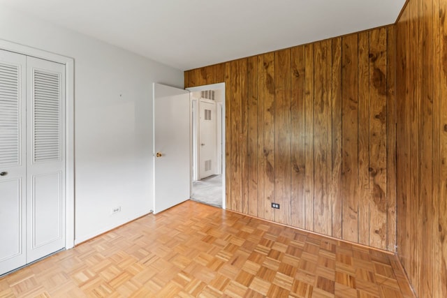 57 Kenilworth Ave, Elk Grove Village, IL 60007 - unfurnished bedroom with wood walls and a closet