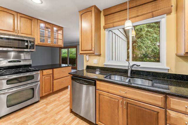 57 Kenilworth Ave, Elk Grove Village, IL 60007 - kitchen featuring stainless steel appliances, light wood-type flooring, pendant lighting, glass insert cabinets, and dark stone counters