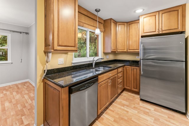 57 Kenilworth Ave, Elk Grove Village, IL 60007 - kitchen featuring appliances with stainless steel finishes, dark stone counters, light wood-style flooring, decorative light fixtures, and brown cabinetry